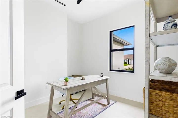 Recessed lighting, tile flooring, and a window with black trim