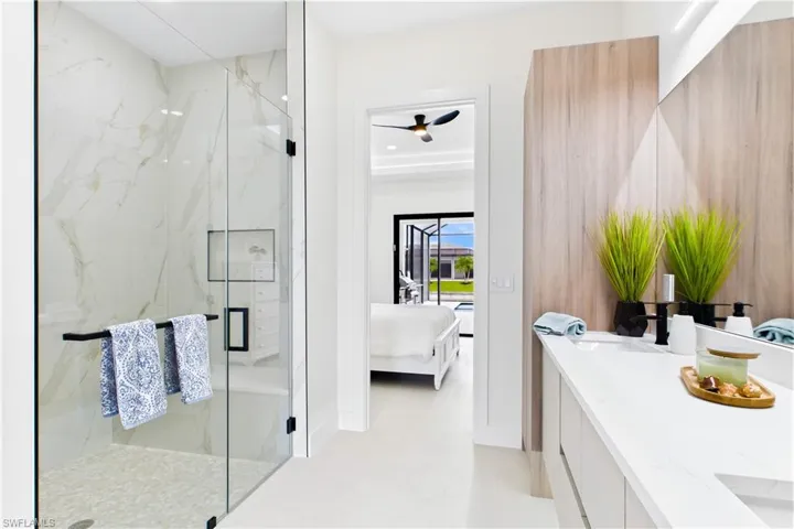Glass-enclosed shower with tiled walls and a built-in niche