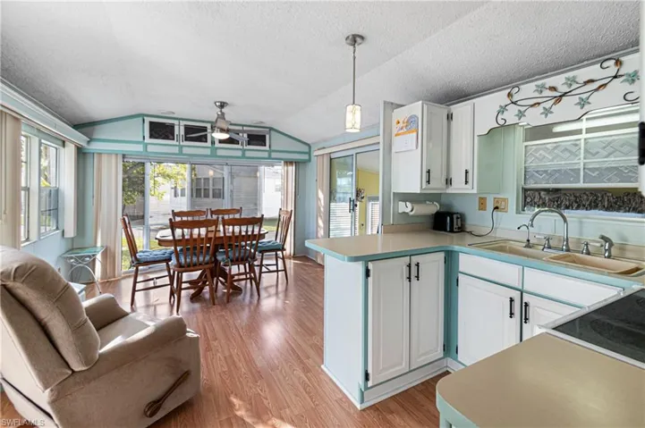 Community laundry room with light tile patterned floors, separate washer and dryer, and stacked washing machine and dryer
