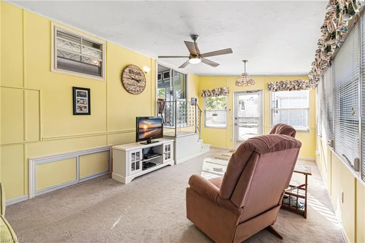 Game room with carpet floors and a paneled ceiling