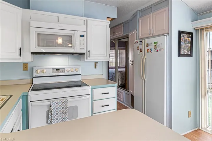 Laundry area with washing machine and dryer, ornamental molding, and ceiling fan