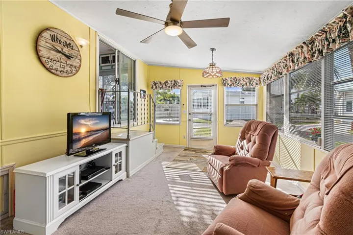 Recreation room with wainscoting, a decorative wall, light carpet, crown molding, and pool table