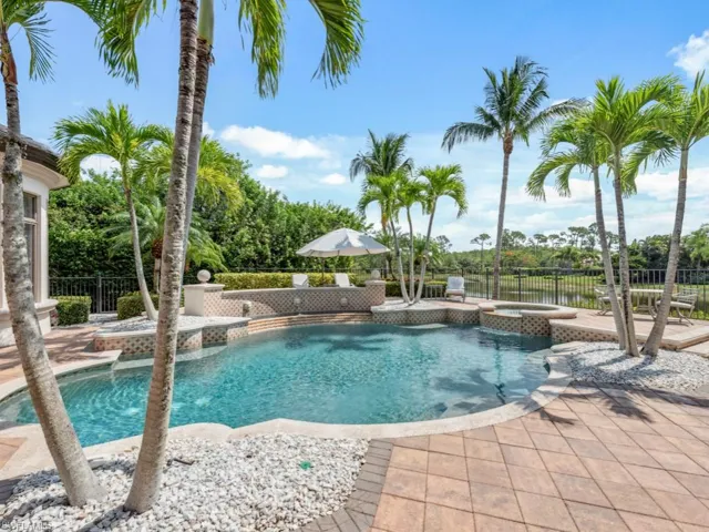 View of swimming sundeck & pool with an integrated spillover spa and fountain