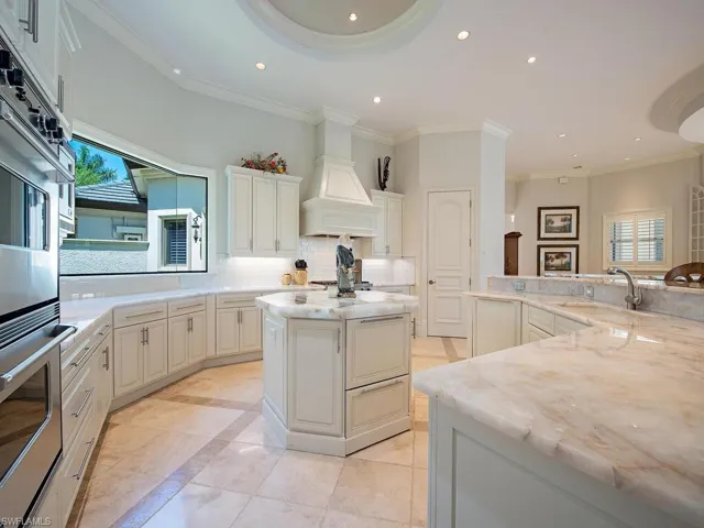 Kitchen w/ Illuminated Quartzite Surfaces, and center insland. large picture window and Viking appliances