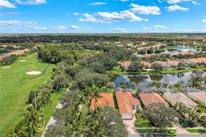 Aerial perspective showcasing extensive golf course frontage, multiple water features, and lush, mature landscaping