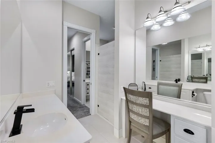 Double vanity with white countertops, undermount sinks, and matte black fixtures
