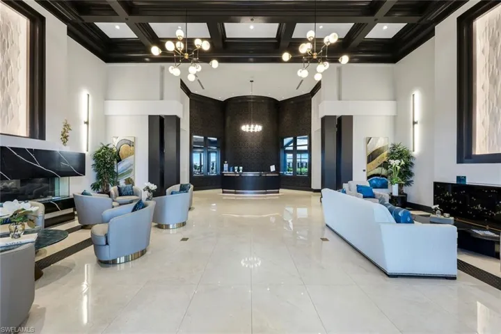 Building lobby with coffered ceiling, beam ceiling, and a high ceiling