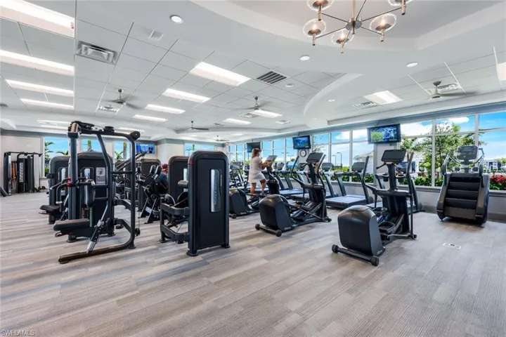 Gym with a chandelier and a paneled ceiling