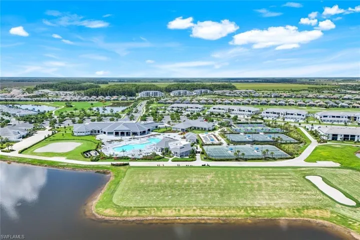 Aerial view of residential area with a large body of water and a local golf course