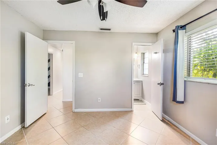 Neutral-toned walls complement the tile flooring