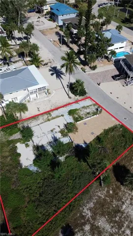 Aerial view of property and surrounding area featuring property boundaries highlighted