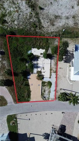 Aerial view of property and surrounding area featuring property parcel outlined.