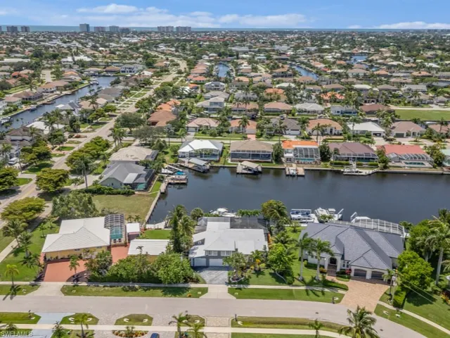 Aerial view of residential area featuring a large body of water