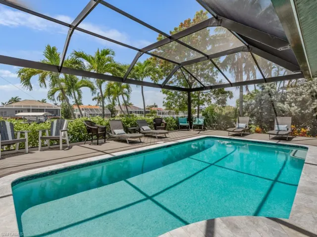 Outdoor pool featuring a patio area and glass enclosure