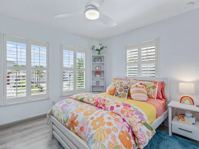 Bedroom with wood finished floors and ceiling fan
