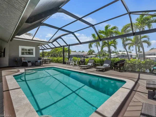 Outdoor pool featuring a patio, a lanai, and an outdoor living space