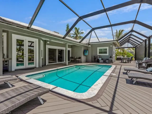 Swimming pool with outdoor dining area, french doors, a patio, and a lanai