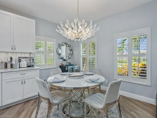 Dining room with light wood-style flooring and a chandelier