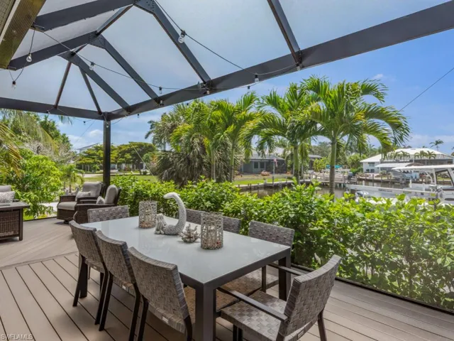 Deck with outdoor dining space and a water view