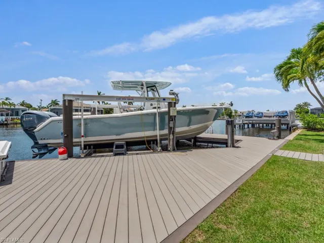Dock area featuring boat lift and a water view