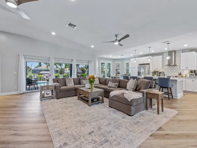 Living room featuring ceiling fan, recessed lighting, plenty of natural light, and light wood-style flooring
