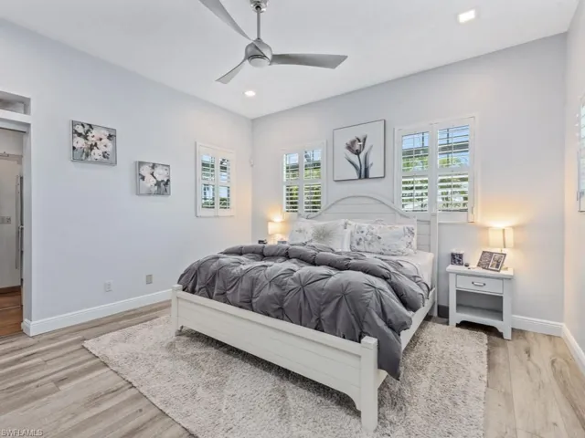 Bedroom with light wood-type flooring, recessed lighting, and a ceiling fan