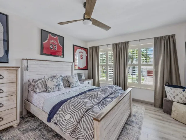 Bedroom with light wood-style flooring and a ceiling fan