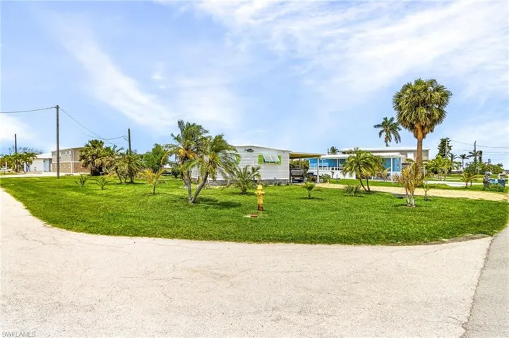 Street view of home.  Large lot with plenty of parking for your boat trailers, RV's, company, etc.  No restrictions.