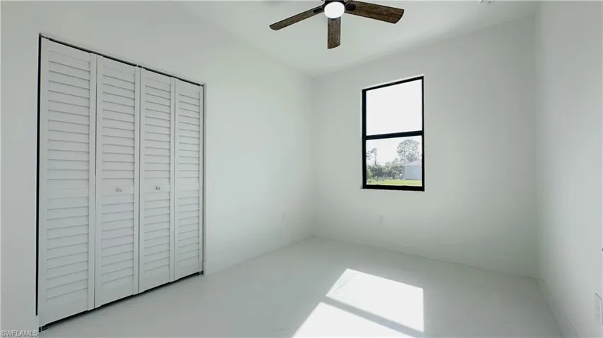 Unfurnished bedroom with a closet and a ceiling fan