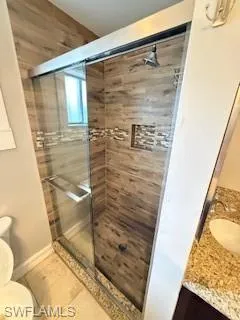 Full bathroom featuring a shower stall and vanity