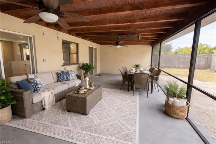 Some pictures virtually staged Sunroom with outdoor lounge area, ceiling fan, beamed ceiling, and a patio