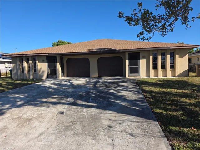 Single story home with stucco siding, driveway, a garage, and a shingled roof
