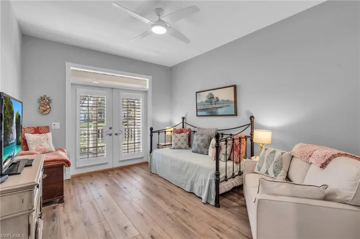 Office or Den french doors to front screened porch  / wood-Look flooring, french doors, access to exterior, and ceiling fan