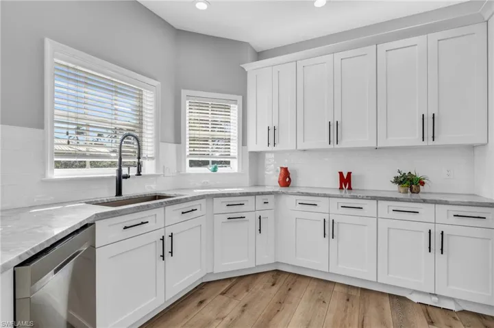 New Kitchen featuring white cabinetry, light wood-look flooring, sink, and plenty of natural light