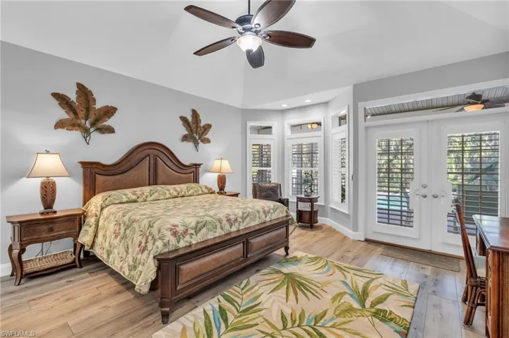 Bedroom with french doors, ceiling fan, access to outside, and light  wood-look floors King size Bed