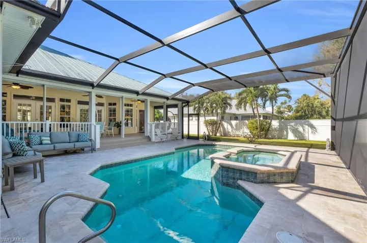View of pool with ceiling fan, outdoor lounge area, an in ground SPA , and Screen enclosure