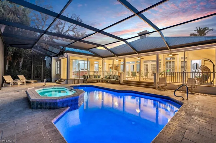 Pool at dusk with a patio, Spa, and ceiling fan