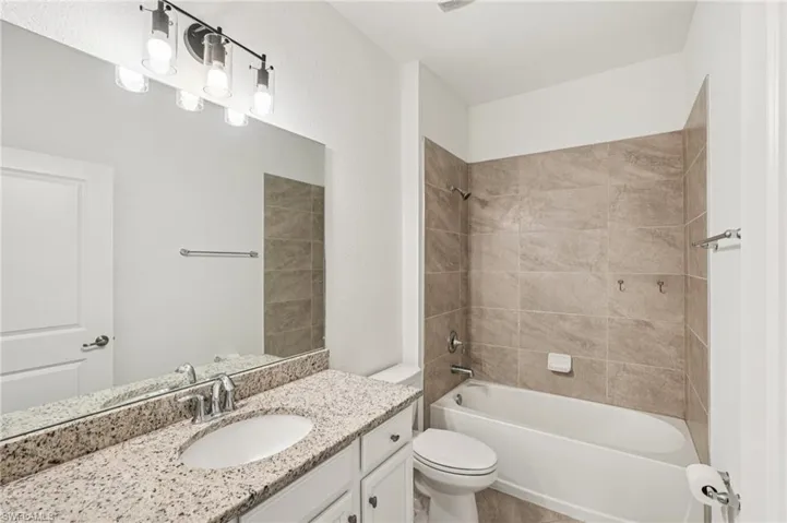 Guest Bathroom featuring bathtub / shower combination and vanity