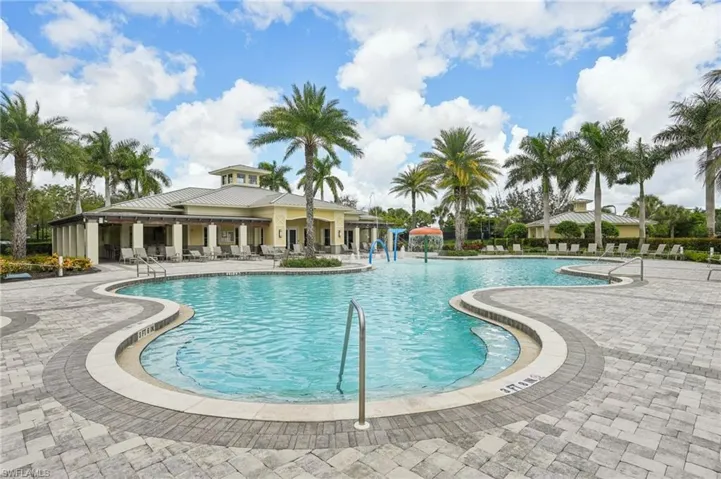 Aerial view of residential area featuring a pool area and a large body of water