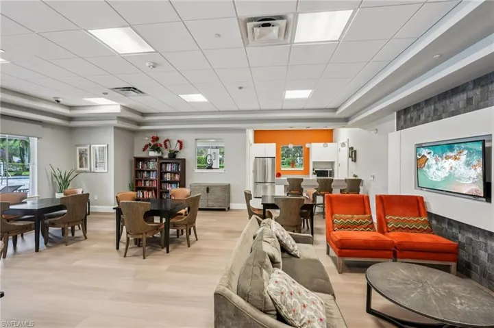 Recreation featuring a tray ceiling, light wood finished floors, and a paneled ceiling