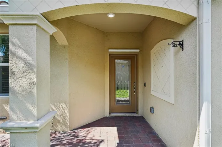 Property entrance with stucco siding
