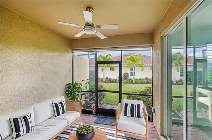 Sunroom / solarium featuring ceiling fan and an outdoor living space