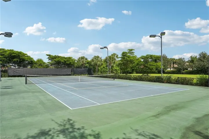 View of tennis court featuring community basketball court