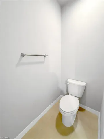 Bathroom with toilet and baseboards