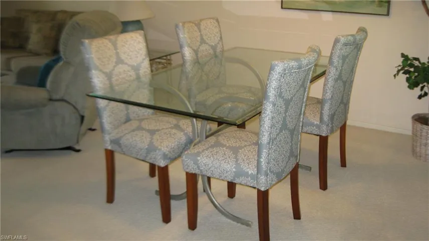 Dining area featuring light carpet