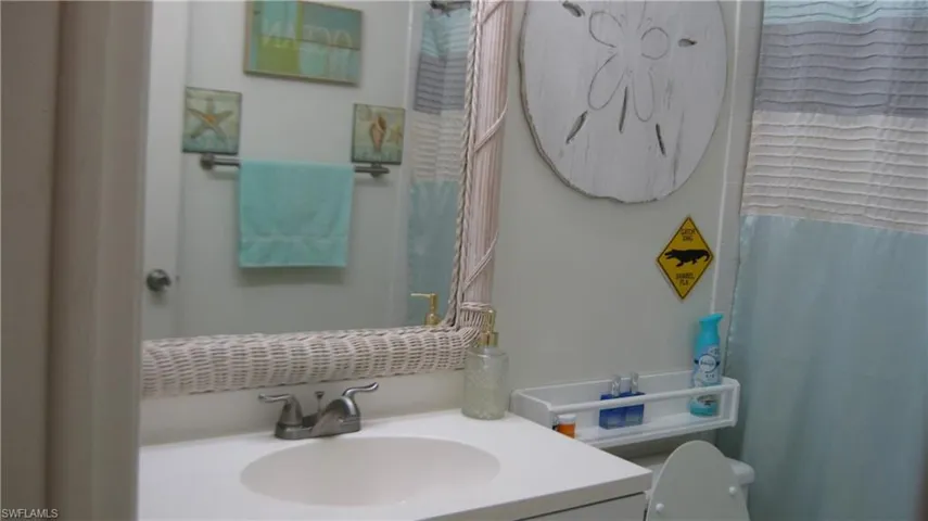 Primary Bathroom featuring new vanity, curtained shower, and toilet