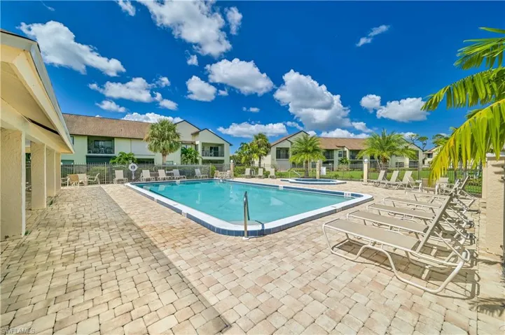 View of pool with a hot tub and a patio area