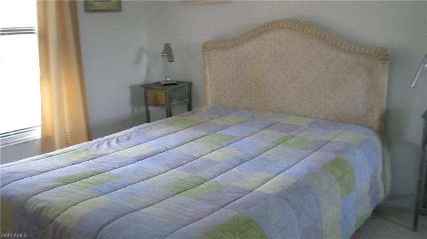 View of guest bedroom with window allowing for natural light.