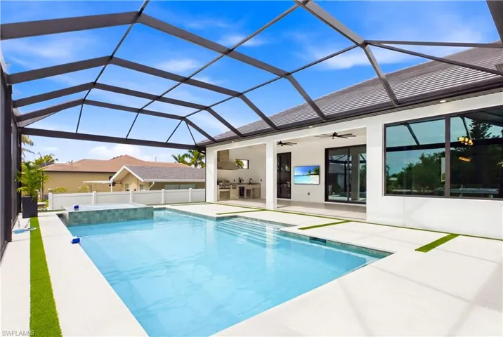 Resort-style screened pool and spa create the perfect outdoor retreat, complemented by an expansive lanai and seamless indoor-outdoor living