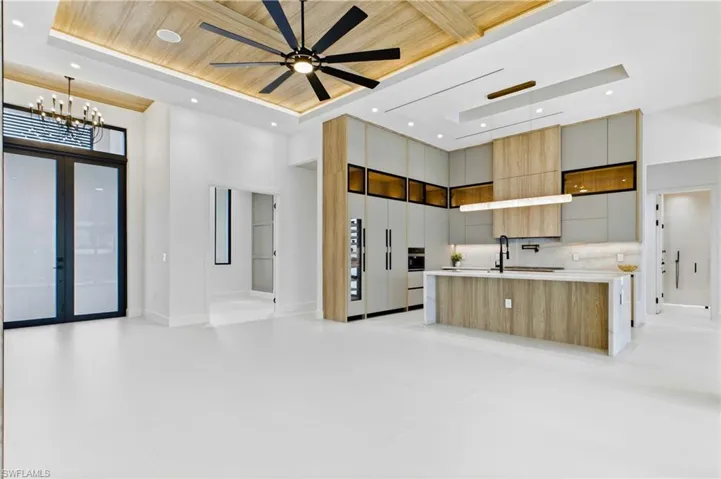 Expansive open-concept living room highlighted by soaring ceilings, designer finishes, and seamless indoor-outdoor flow!
